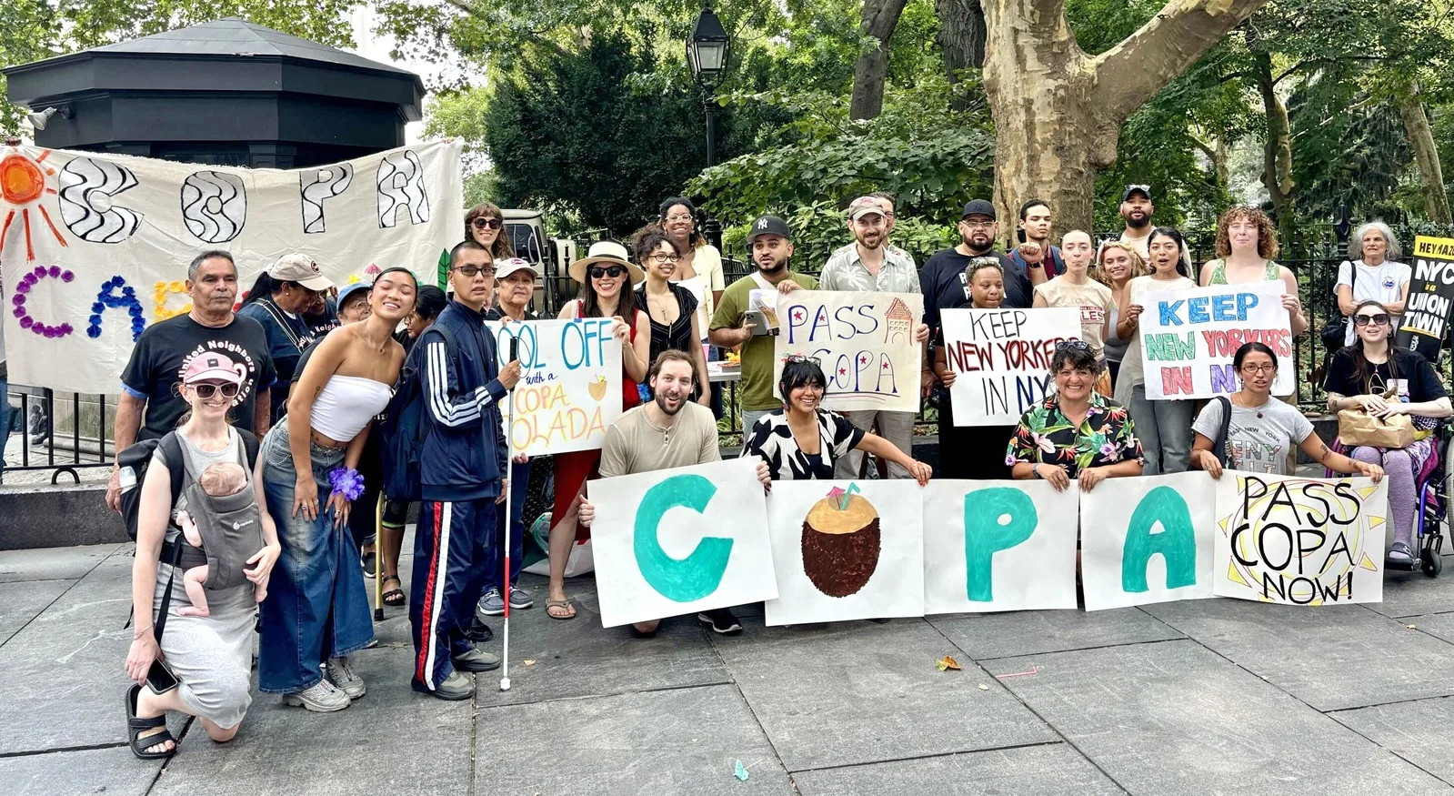 Group of COPA supporters gather near City Hall with signs supporting the legislation.